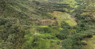 Hawaii beach surrounded by mountains.